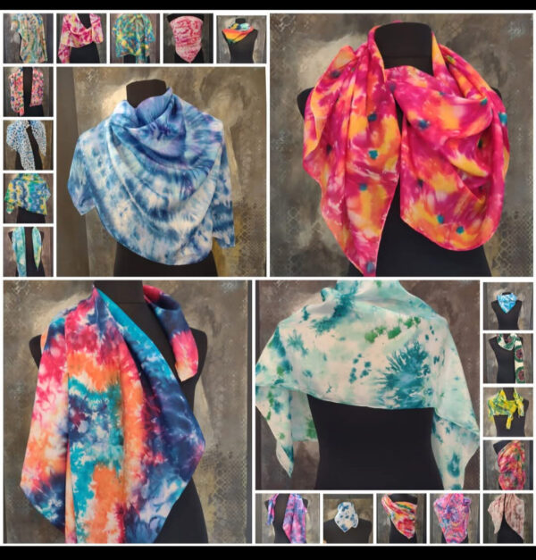Deelnemers schilderen een kleurrijke of pastel zijden sjaal tijdens een creatieve workshop.